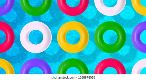 colorful swimming rings float on pool water surface background