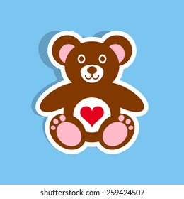Colorful teddy bear with heart label on blue