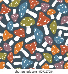 Colorful toadstool or fly agaric mushroom seamless pattern over dark blue background. Vector illustration.