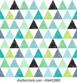 Colorful triangles with white splash or blobs texture seamless vector pattern. Triangles with uneven spots, specks, blots texture. Geometric abstract background. Shades of green.