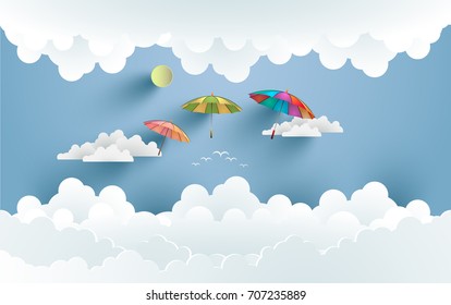 colorful umbrellas fly over clouds. design with art paper and craft.