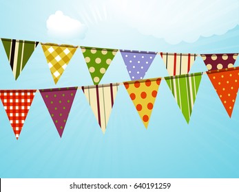 Colorful Vintage Bunting Over Blue Sunny Sky with Clouds