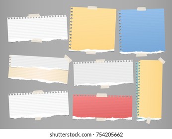 Colorful and white ripped strips, notebook, note paper for text or message stuck with sticky tape on gray background