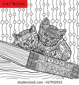 Coloring cat page for adults. Two funny kitten sitting on book. Hand drawn illustration with patterns. Zenart