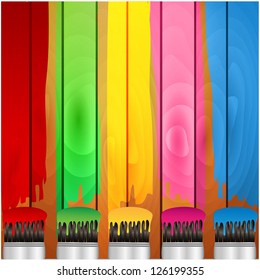 coloured stripes of paint and brush on a background wooden boards