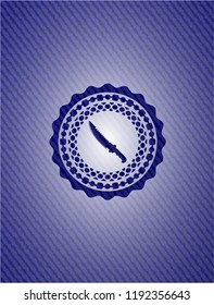 combat knife icon inside badge with jean texture