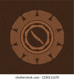 combat knife icon inside badge with wooden background