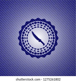 combat knife icon inside badge with jean texture