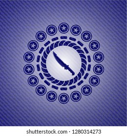 combat knife icon inside badge with denim texture
