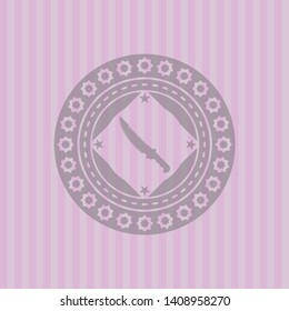 combat knife icon inside badge with pink background