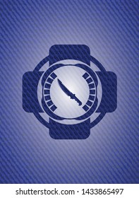 combat knife icon inside badge with denim background