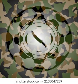 combat knife icon inside camouflaged emblem. 