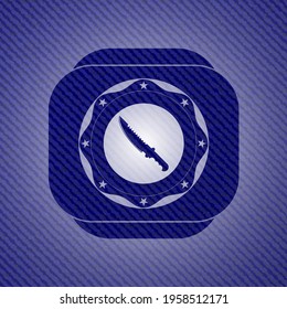 combat knife icon inside denim background. 