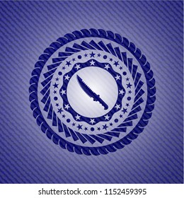 combat knife icon inside emblem with jean texture