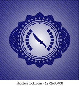 combat knife icon inside emblem with denim high quality background
