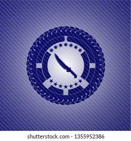 combat knife icon inside emblem with denim texture