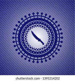 combat knife icon inside emblem with jean background
