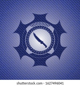 combat knife icon inside emblem with jean background