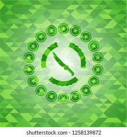 combat knife icon inside green mosaic emblem