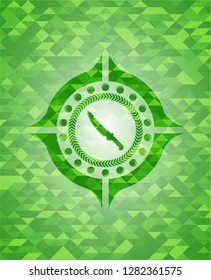 combat knife icon inside green emblem with triangle mosaic background