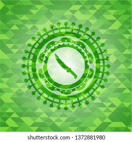 combat knife icon inside green mosaic emblem