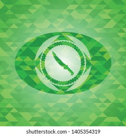 combat knife icon inside green emblem with triangle mosaic background