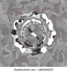 combat knife icon inside grey camouflage texture