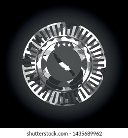 combat knife icon inside grey camo emblem