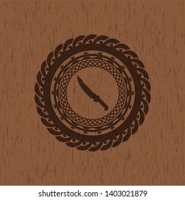 combat knife icon inside retro wooden emblem