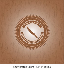 combat knife icon inside wood emblem