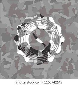 combat knife icon on grey camouflage texture