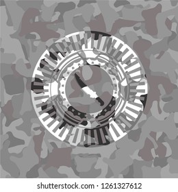 combat knife icon on grey camouflaged texture