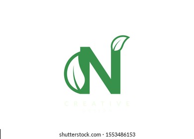 The combination of leaves and letters of the alphabet. Minimalist and simple design in green