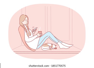 Comfortable relaxing at home with smartphone and hot drink. Young happy girl cartoon character sitting on windowsill with tea, chatting online on smartphone, enjoying rest at home near sleeping cat