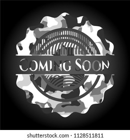 Coming Soon written on a grey camouflage texture