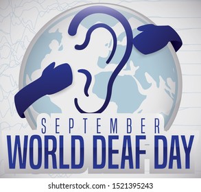Commemorative button with deafness symbol and hands hugging it, representing the solidarity and sensitization of deaf community during World Deaf Day in September.