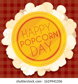 Commemorative golden button with greeting message over corn popper stacking squared tablecloth for Popcorn Day celebration.