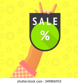 commercial illustration depicting hand holding tablet with inscription sale and percent sign on yellow spotted background of green circle long shadow. discount trade event eps advertising download