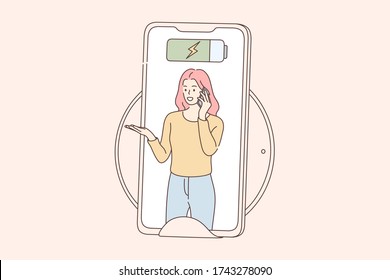 Communication, charging, technology concept. Young woman or girl cartoon character speaking by mobile phone near cordless pad for charged induction. Wireless electrical wifi accessory for smartphone.