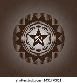 communism icon inside badge with wooden background