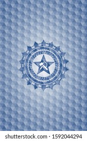 communism icon inside blue badge with geometric background.