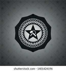 communism icon inside dark emblem