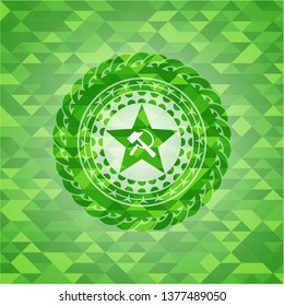 communism icon inside green emblem with triangle mosaic background