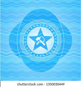 communism icon inside light blue water style badge.