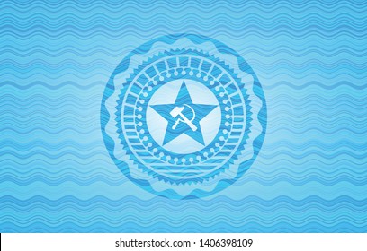 communism icon inside light blue water wave emblem background.