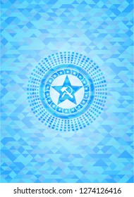 communism icon inside sky blue emblem with triangle mosaic background
