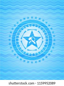 communism icon inside water wave emblem.