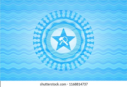 communism icon inside water wave style emblem.