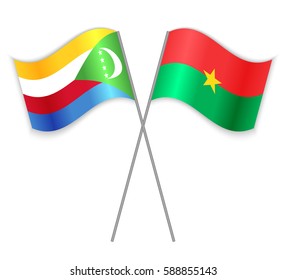 Comoran and Burkinabe crossed flags. Comoros combined with Burkina Faso isolated on white. Language learning, international business or travel concept.