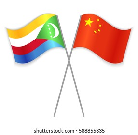 Comoran and Chinese crossed flags. Comoros combined with China isolated on white. Language learning, international business or travel concept.